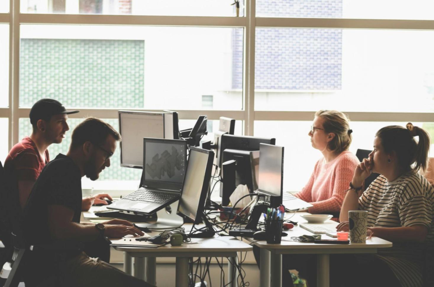 Professional analyzing complex financial data and market trends on multiple screens
